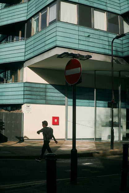 Captured this one on an early morning photo walk to work. Just when I was about to put the camera away getting ready to step into the office I walked into this scene. I loved the early morning contrast combined with the characters rushing to get in on time. This bloke entered the scene at the perfect moment.